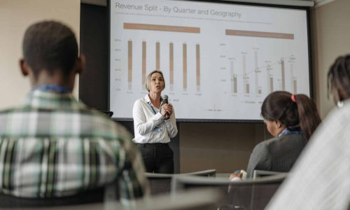 Professional presentation on revenue split by quarter and geography during a business conference.